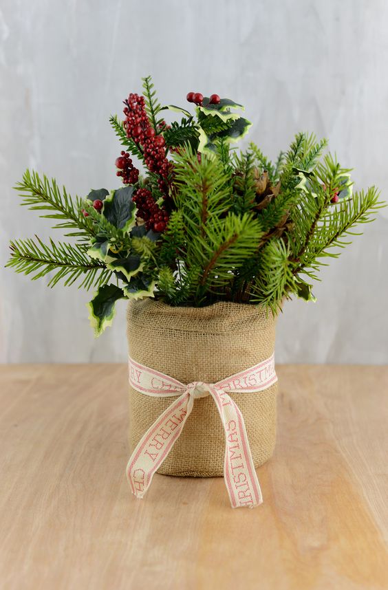 24-a-burlap-wrapped-pot-with-evergreens-leaves-and-berries