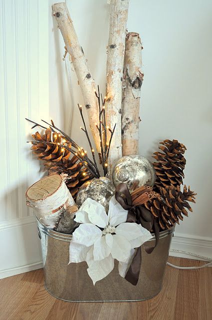 26-a-galvanized-bucket-with-branches-pinecones-ornaments-and-a-poinsettia
