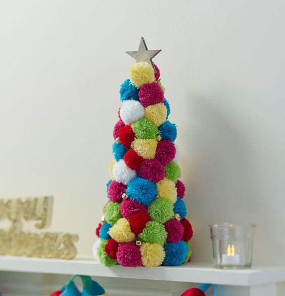  23 a super colorful pompom Christmas tree with beads and a star on top can be crafted in addition to a usual tree