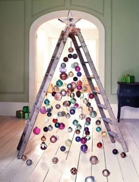  25 a chic ladder christmas tree with colorful ornaments all over and on the floor for a messy and relaxed touch